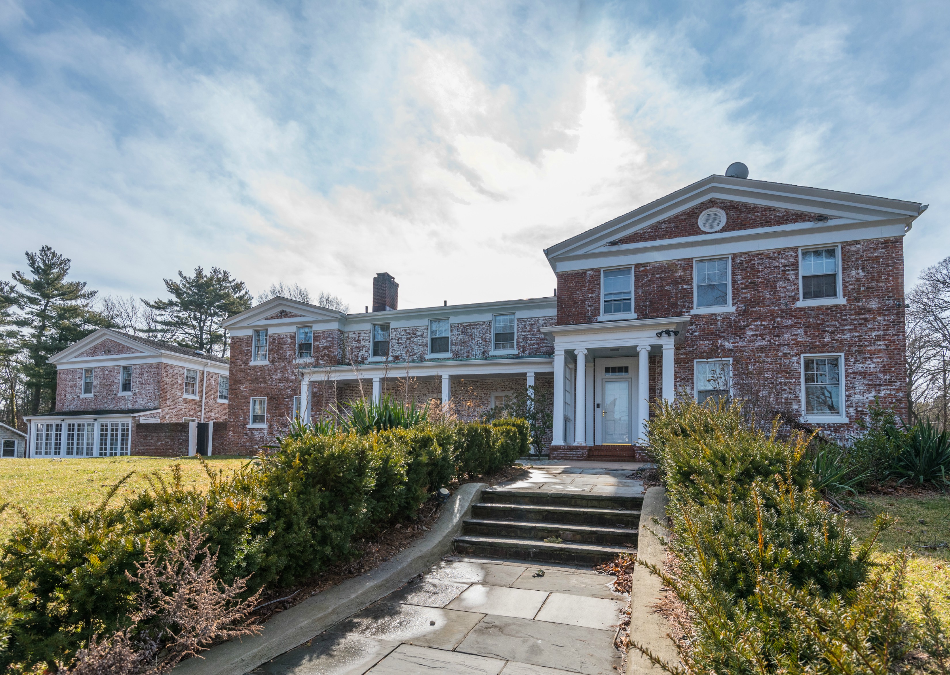 Price Improved!  Charming white-washed brick manor in the heart of old westbury